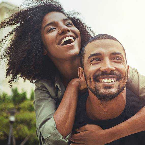 A man and woman share a joyful moment, smiling and laughing together IN & Bowling Green, KY