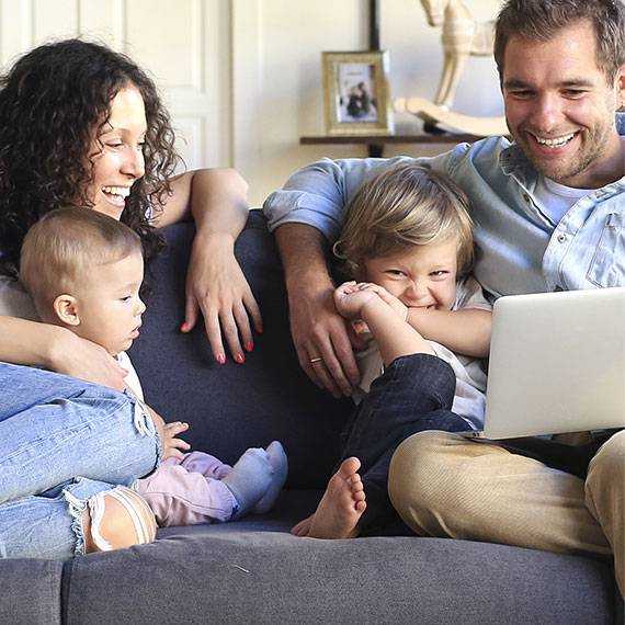 Ready to Move In Now? Search Our Move-in Ready Homes A family gathered on a couch, engaging with a laptop together IN & Bowling Green, KY