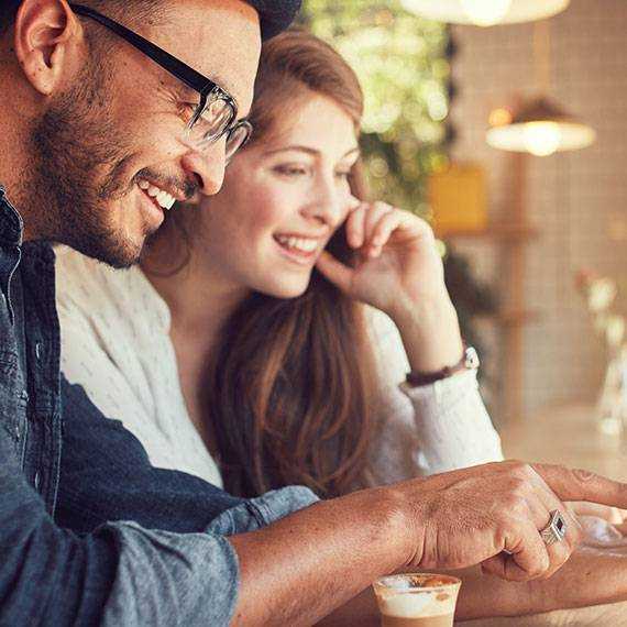 Why Buy New? A man and woman are engaged in viewing a tablet together IN & Bowling Green, KY