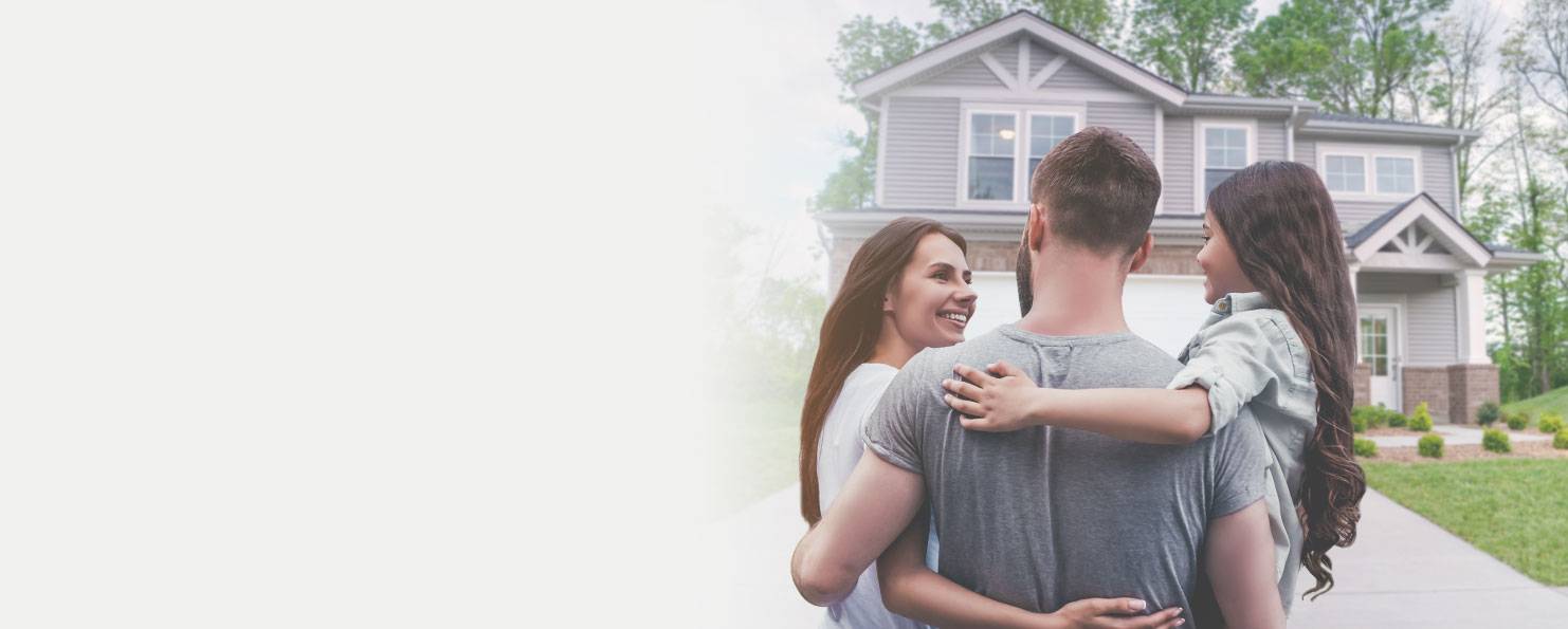 A couple joyfully hugs each other in front of their residence IN & Bowling Green, KY
