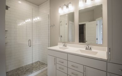 Owner's Bath Owner’s Bath in the Emory Craftsman floor plan by Jagoe Homes, featuring a spacious double vanity, a tiled walk-in shower, and modern finishes for a luxurious and functional design