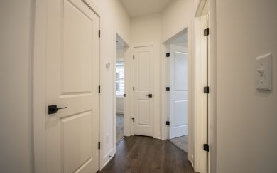 Hallway to secondary bedrooms and bath in the Angelico Craftsman floor plan by Jagoe Homes