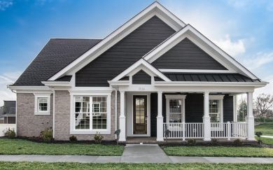 Malbec Front view of the Malbec traditional home, featuring a combination of horizontal LP Smartside and brick, a gabled roofline, and a welcoming front porch with white columns and railing.