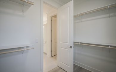 Owner's Closet Walk-in closet with built-in shelving and hanging rods, located off the owner’s bath.