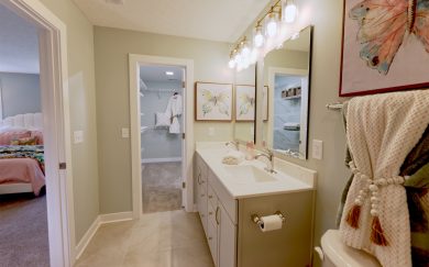 Owner's Bath | Owner's Closet Owner's Bath featuring ceramic tile shower and double bowl vanity and Owner's Closet in the Cumberland Farmhouse floor plan by Jagoe Homes