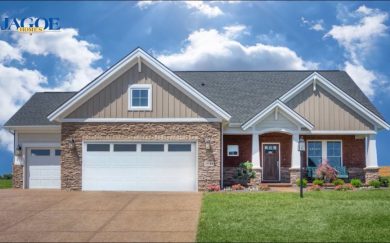 Walnut Craftsman C2 3 Car Garage | Waterstone Village | Newbugh, IN A stunning home in Owensboro, KY, with a garage & a well-maintained driveway, showcasing its exterior.