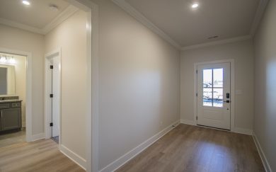 Foyer and hallway leading to Bedroom 2 and Bath 2 in the Arizona Craftsman floor plan by Jagoe Homes.