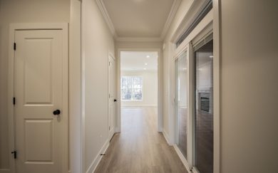 Hallway leading to the screened, covered patio and family room in the Arizona Craftsman floor plan by Jagoe Homes.