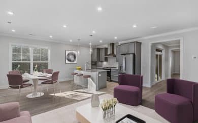 Furnished Great Room, Dining Area, and deluxe kitchen with optional features in the Arizona Craftsman floor plan by Jagoe Homes.