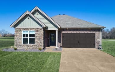 Carolina Craftsman Front exterior of the Carolina Craftsman floor plan by Jagoe Homes, featuring stone, brick, and decorative siding