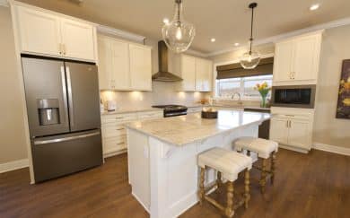 Upgraded Kitchen Layout w/ Deluxe Features Upgraded layout featuring a deluxe kitchen with granite countertops, soft-close cabinetry in the Carolina Craftsman floor plan by Jagoe Homes.