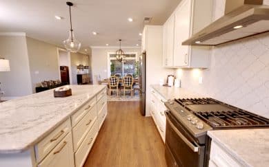 Kitchen | Dining Area Kitchen area with a view of the Dining Area and covered patio in the Carolina Craftsman floor plan by Jagoe Homes.