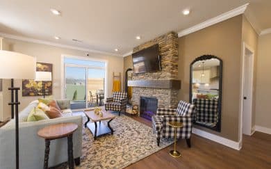 Great Room Great Room with an electric fireplace with floor-to-ceiling stone in the Carolina Craftsman floor plan by Jagoe Homes.