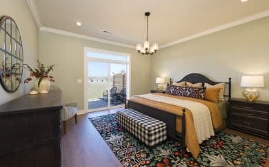 Owner's Suite Owner’s Suite with sliding doors leading to the outdoor retreat in the Carolina Craftsman floor plan by Jagoe Homes.