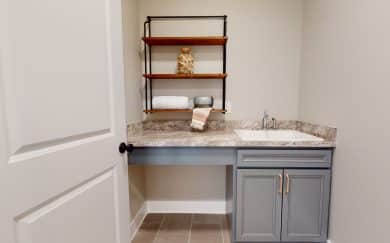 Deluxe Laundry Deluxe laundry room featuring countertops, cabinets, and a laundry tub in the Carolina Craftsman floor plan by Jagoe Homes.