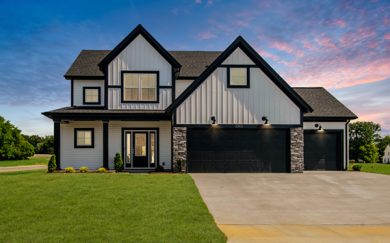National-Modern-with-3-car-garage Head-on exterior view of the national farmhouse floorplan at sunset