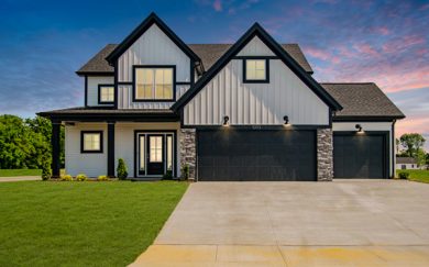 National-Modern-with-3-car-garage-Sunset Head-on exterior view of the national farmhouse floorplan at sunset