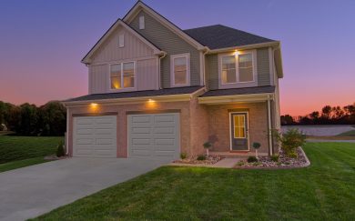 Dusk shot of the Cumberland Modern floor plan by Jagoe Homes, featuring soffit lighting for enhanced curb appeal.